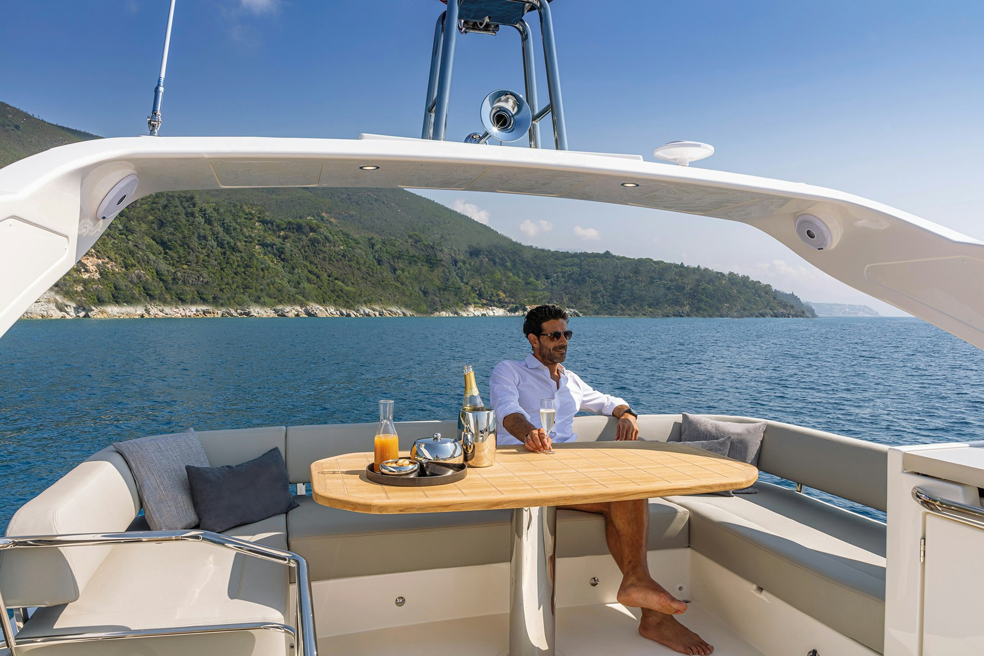 Man sitting at table on yacht.